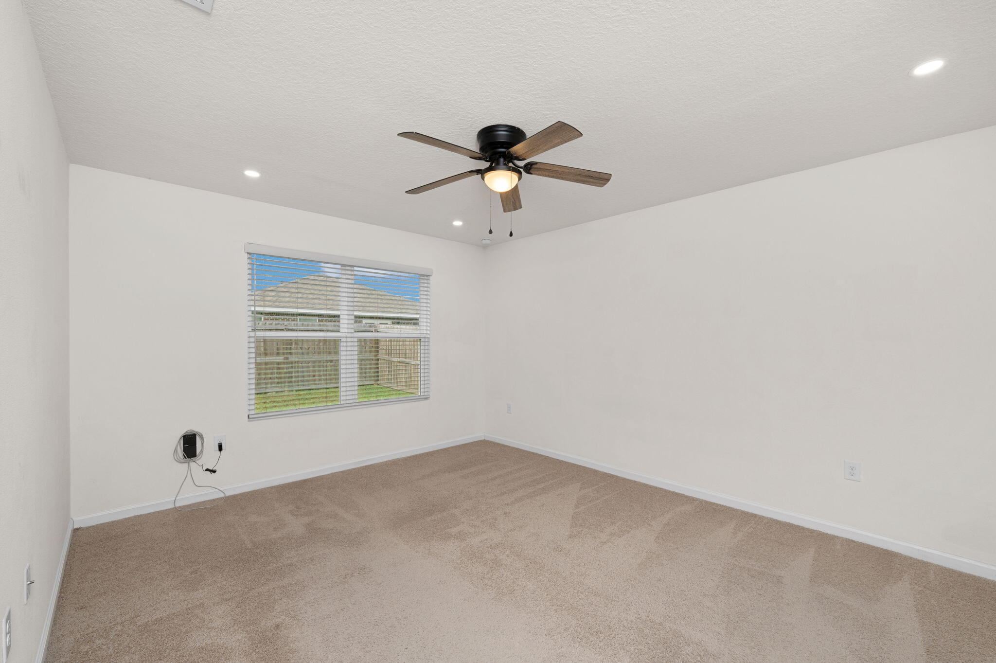 920 Merganser Way Crestview, FL 32539 - Photo 16 of 39 an empty room with a window and a ceiling fan