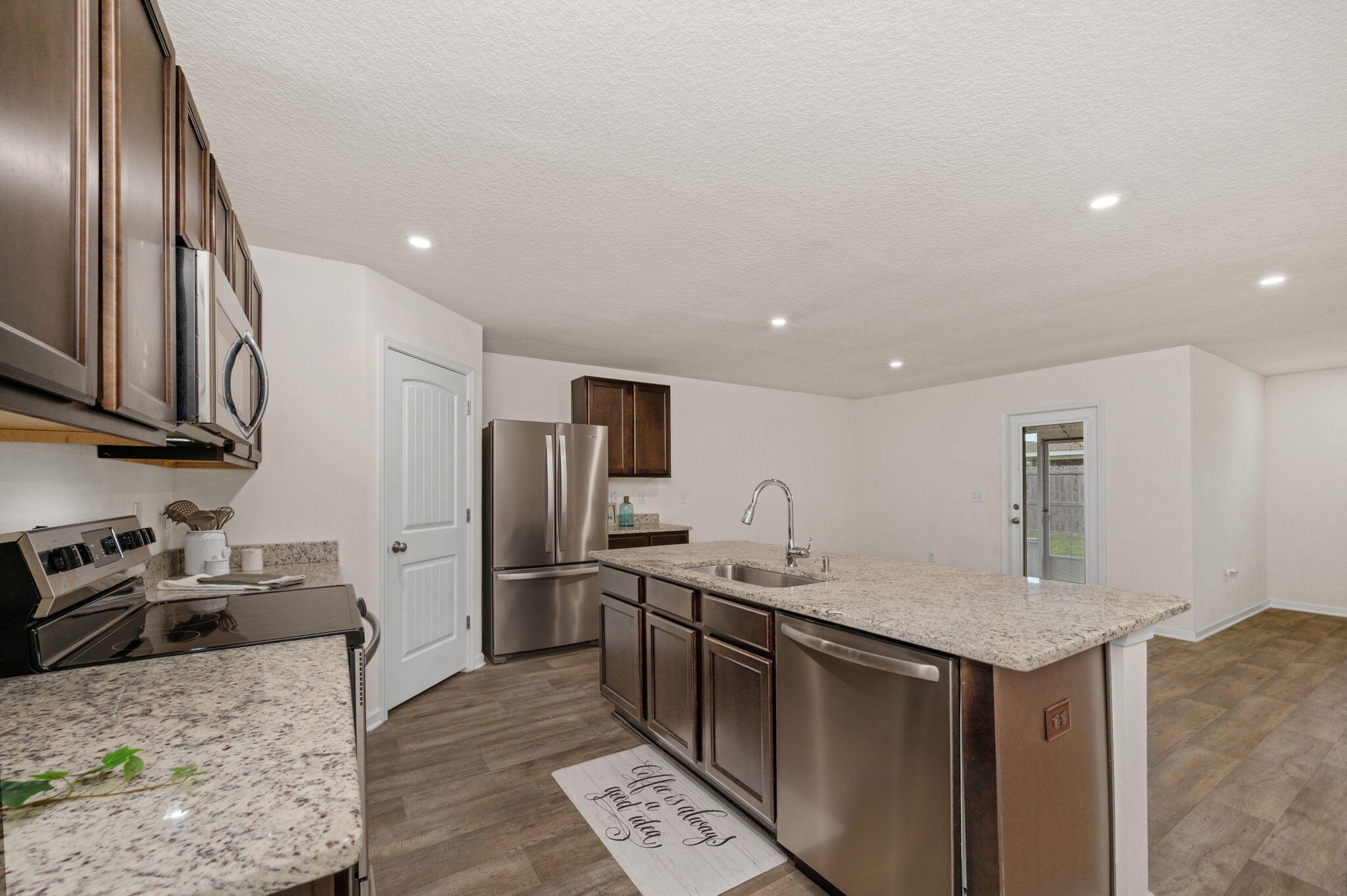 920 Merganser Way Crestview, FL 32539 - Photo 7 of 39 a kitchen with stainless steel appliances granite countertop a sink stove and refrigerator