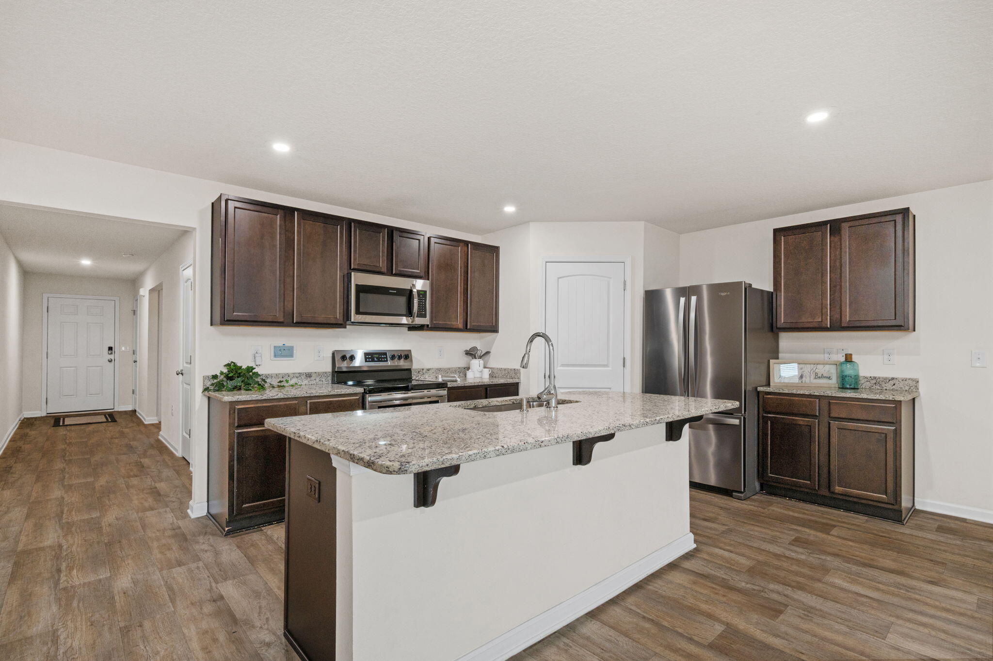 920 Merganser Way Crestview, FL 32539 - Photo 8 of 39 a kitchen with a sink a stove a refrigerator cabinets and a window