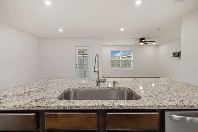 a kitchen with granite countertop a sink and a granite counter tops