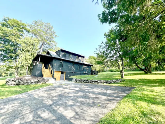 a house that has a tree in front of it