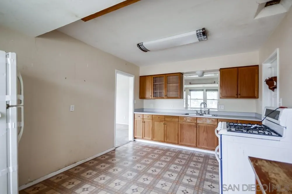 6316 Streamview Drive San Diego, CA 92115 - Photo 21 of 52 a kitchen with stainless steel appliances granite countertop a sink stove and cabinets
