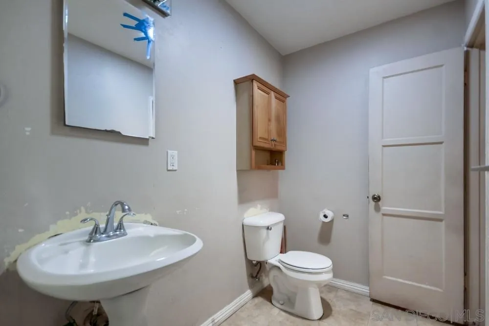 6316 Streamview Drive San Diego, CA 92115 - Photo 24 of 52 a bathroom with a sink a toilet and mirror