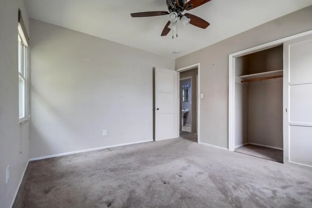 6316 Streamview Drive San Diego, CA 92115 - Photo 28 of 52 a view of an empty room with a ceiling fan