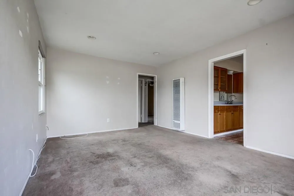 6316 Streamview Drive San Diego, CA 92115 - Photo 9 of 52 a view of an empty room with closet and wooden door