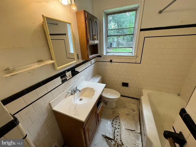 a bathroom with a sink a toilet and mirror