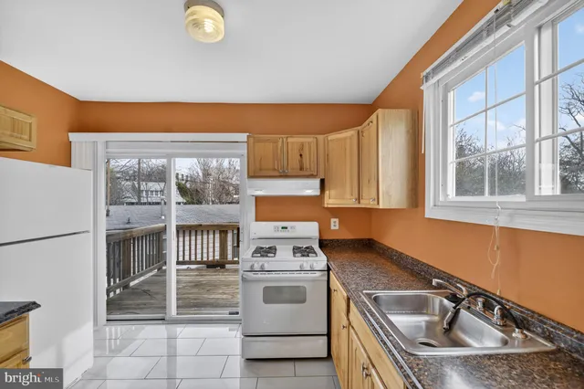 a view of a roof deck with couches and potted plants