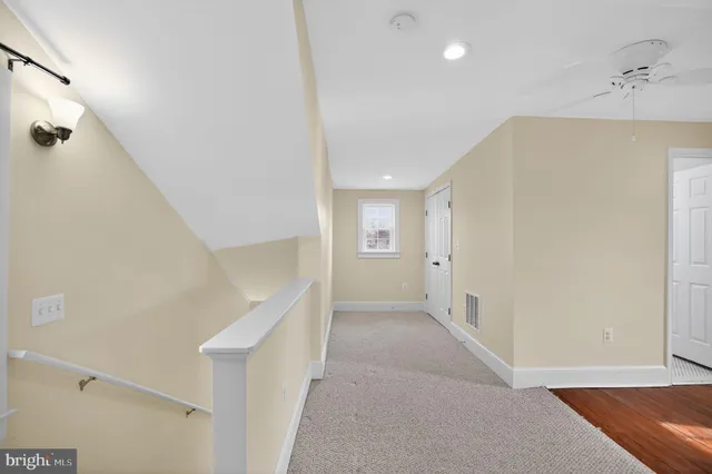 a view of an empty room and wooden floor
