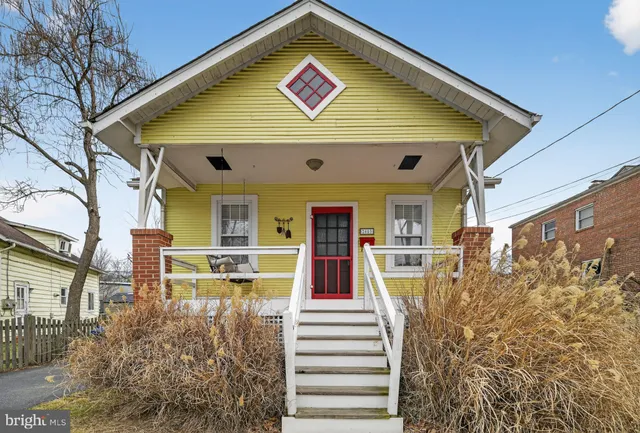 a view of a house with large windows and a small yard