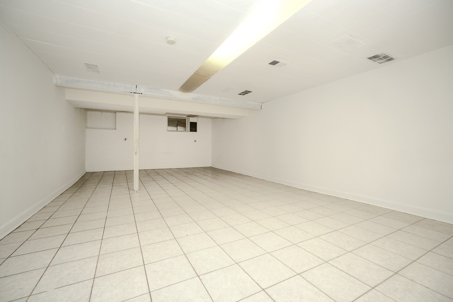 1010 North Elmhurst Road Prospect Heights, IL 60070 - Photo 13 of 15 an empty room with white walls and tiles