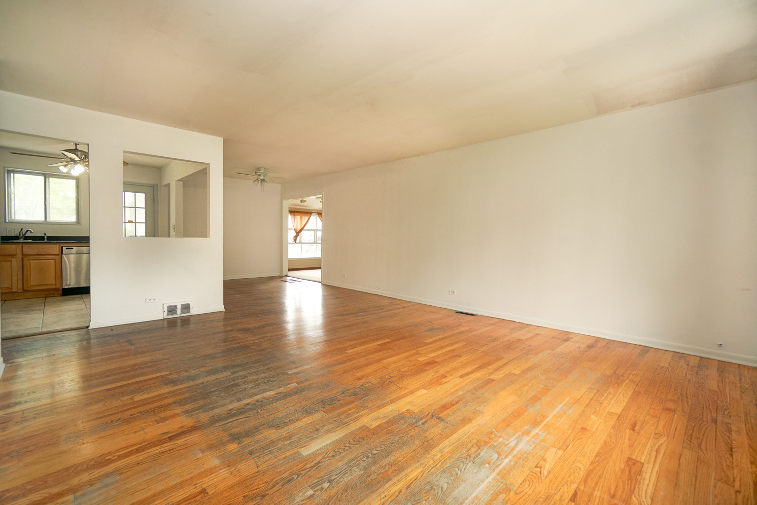 1010 North Elmhurst Road Prospect Heights, IL 60070 - Photo 2 of 15 a view of empty room with wooden floor and fan