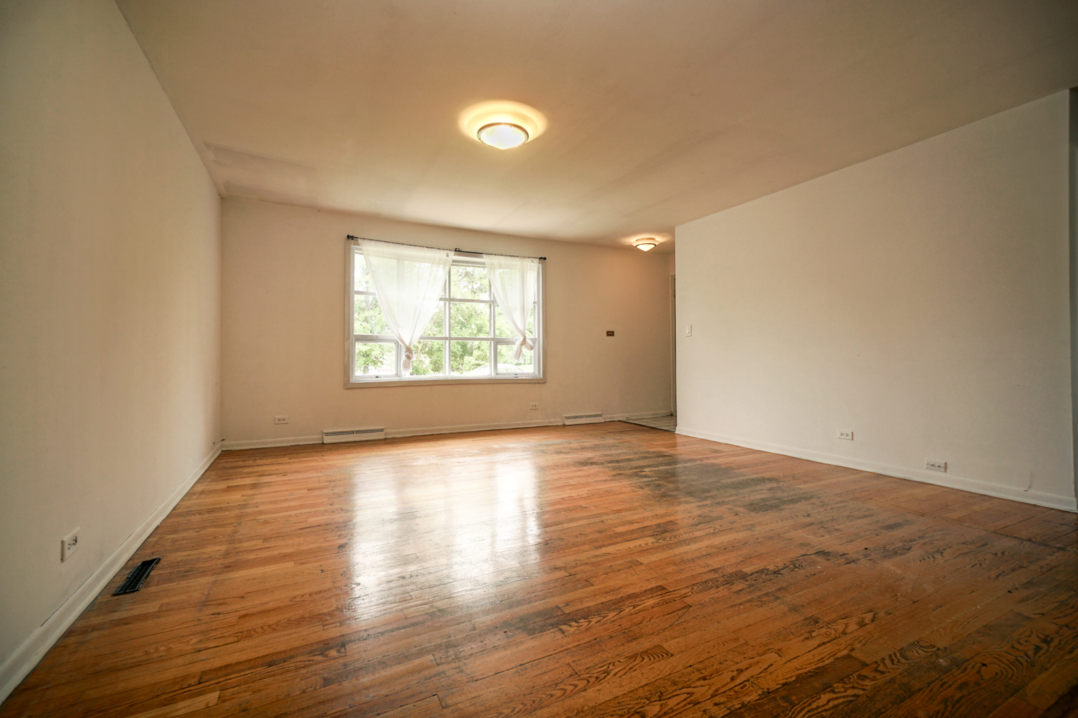 1010 North Elmhurst Road Prospect Heights, IL 60070 - Photo 3 of 15 an empty room with wooden floor and windows