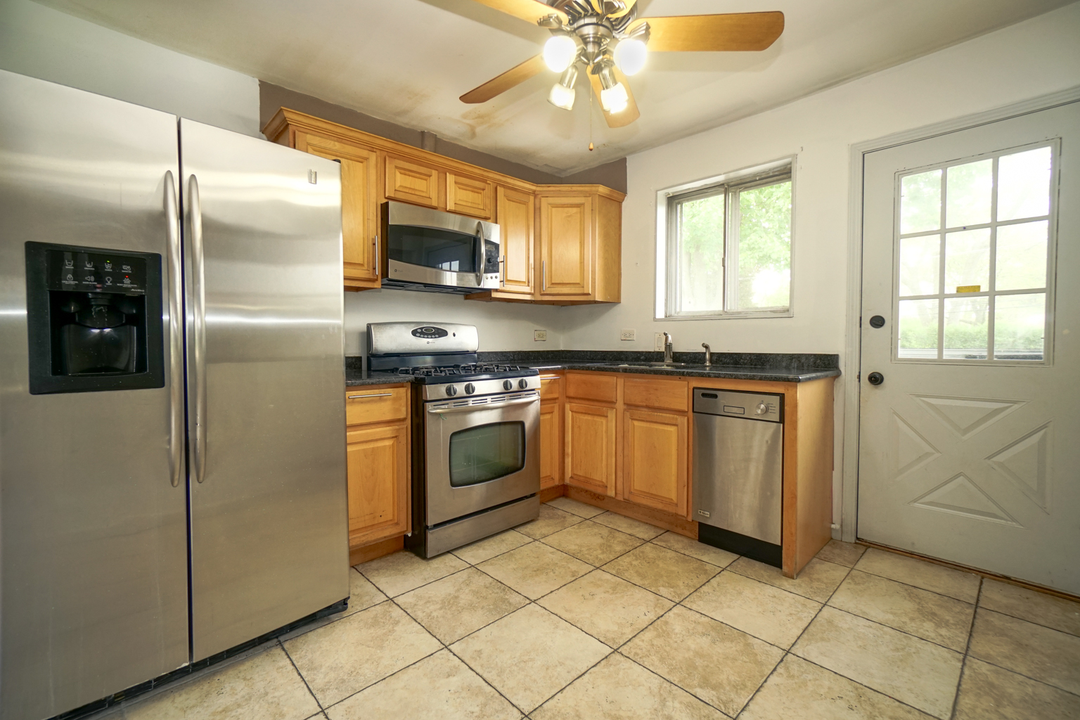1010 North Elmhurst Road Prospect Heights, IL 60070 - Photo 4 of 15 a kitchen with cabinets stainless steel appliances and window