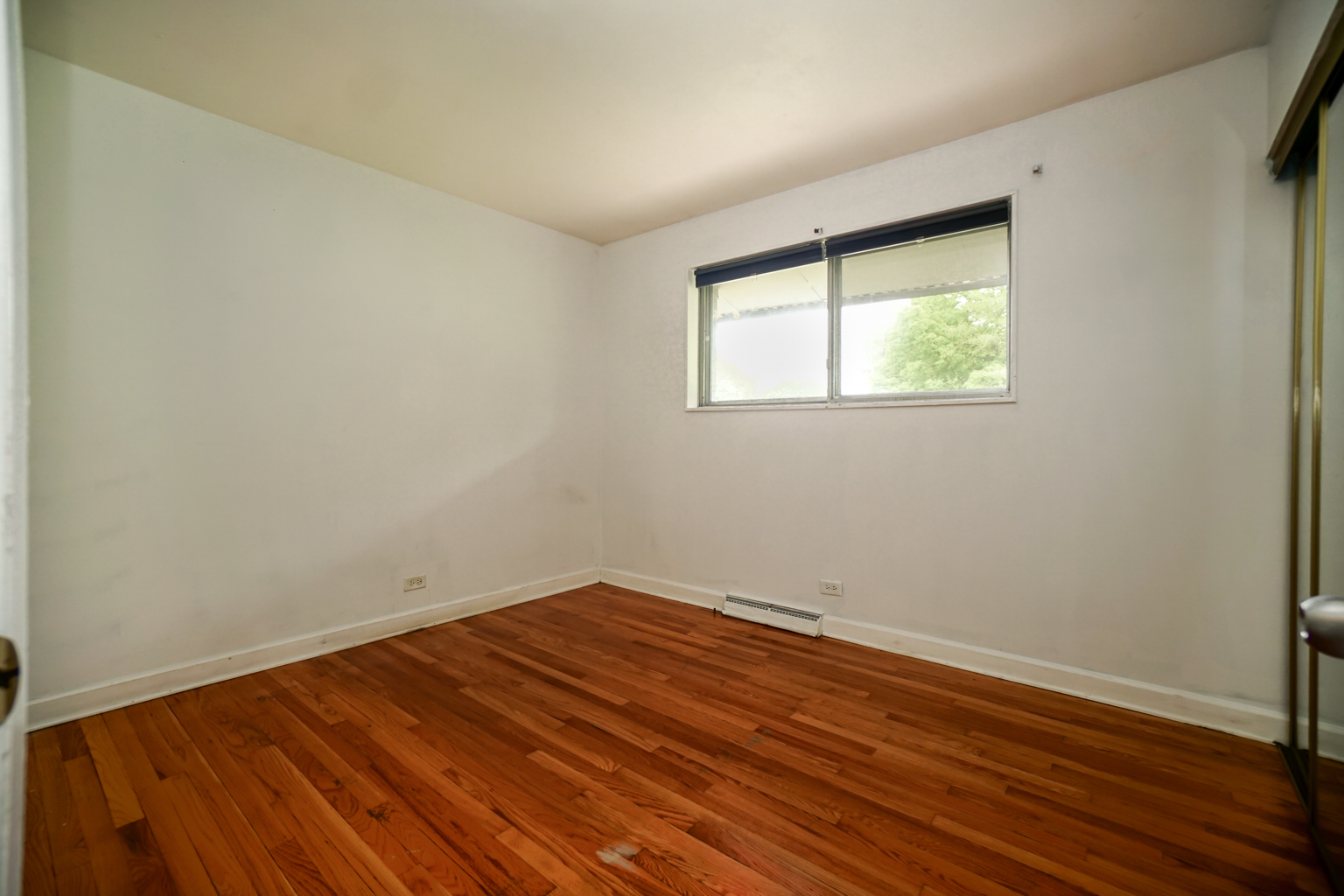 1010 North Elmhurst Road Prospect Heights, IL 60070 - Photo 7 of 15 an empty room with wooden floor and windows