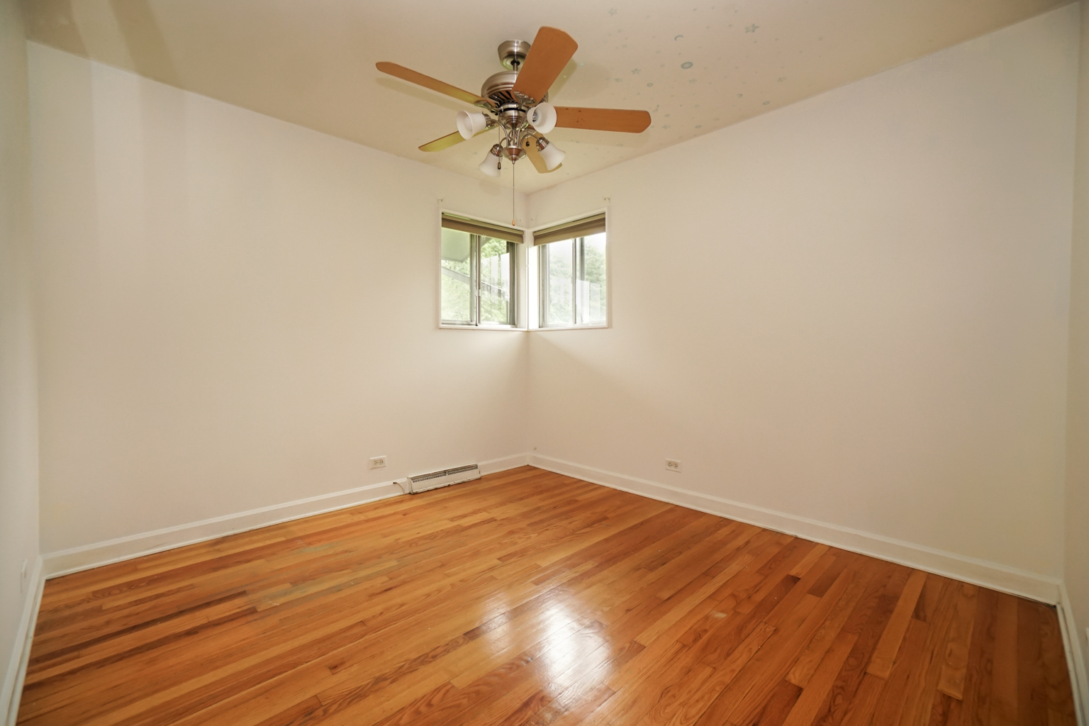 1010 North Elmhurst Road Prospect Heights, IL 60070 - Photo 8 of 15 a view of a room with wooden floor and a ceiling fan