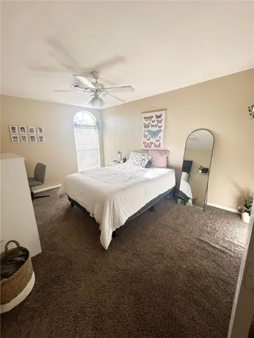 a bedroom with a bed a couch and dresser