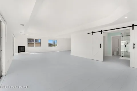 a view of a livingroom with an empty space and a window