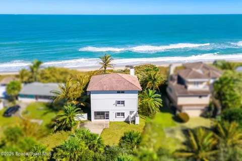 a aerial view of a house with a yard
