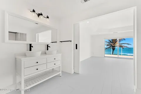 a view of an empty room with window and cabinet