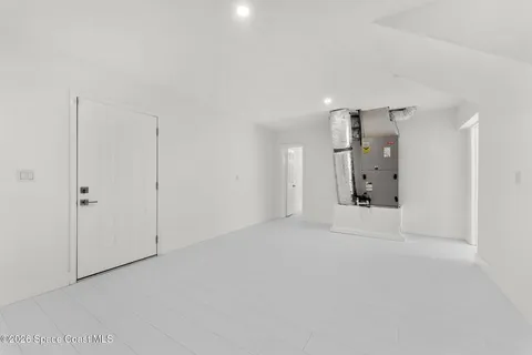 a spacious bedroom with a bed and a cabinets