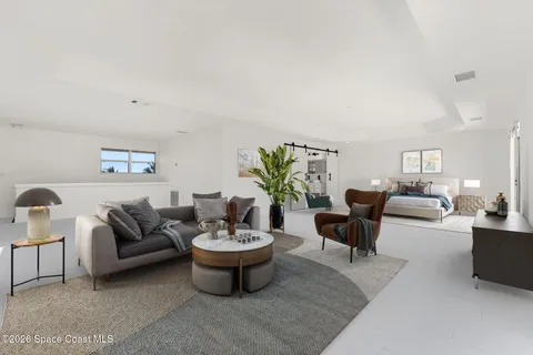 a bedroom with a bed and a couch