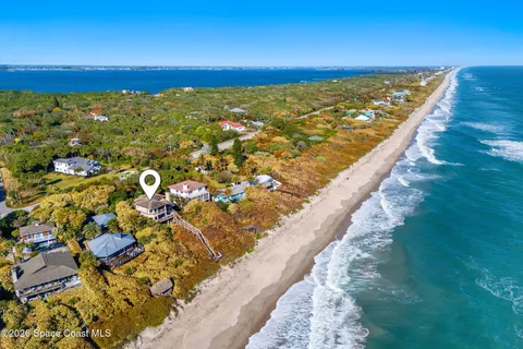 a view of balcony with floor to ceiling windows and wooden floor