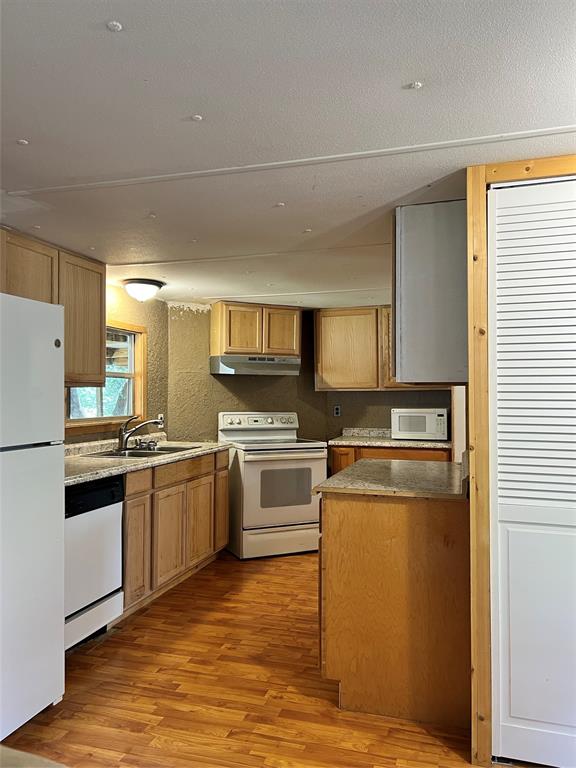 2334 San Bar Road, Unit 46 Graford, TX 76449 - Photo 7 of 37 a kitchen with stainless steel appliances granite countertop a refrigerator a stove top oven a sink and dishwasher