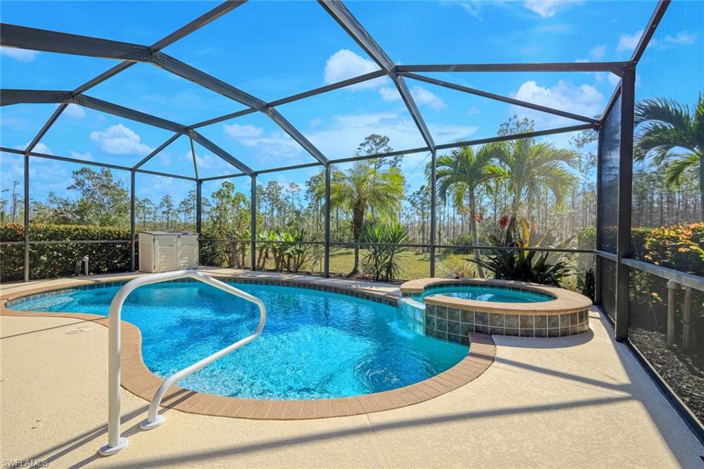 21025 Bella Terra Boulevard Estero, FL 33928 - Photo 1 of 35 a blue swimming pool with a outdoor seating yard and patio