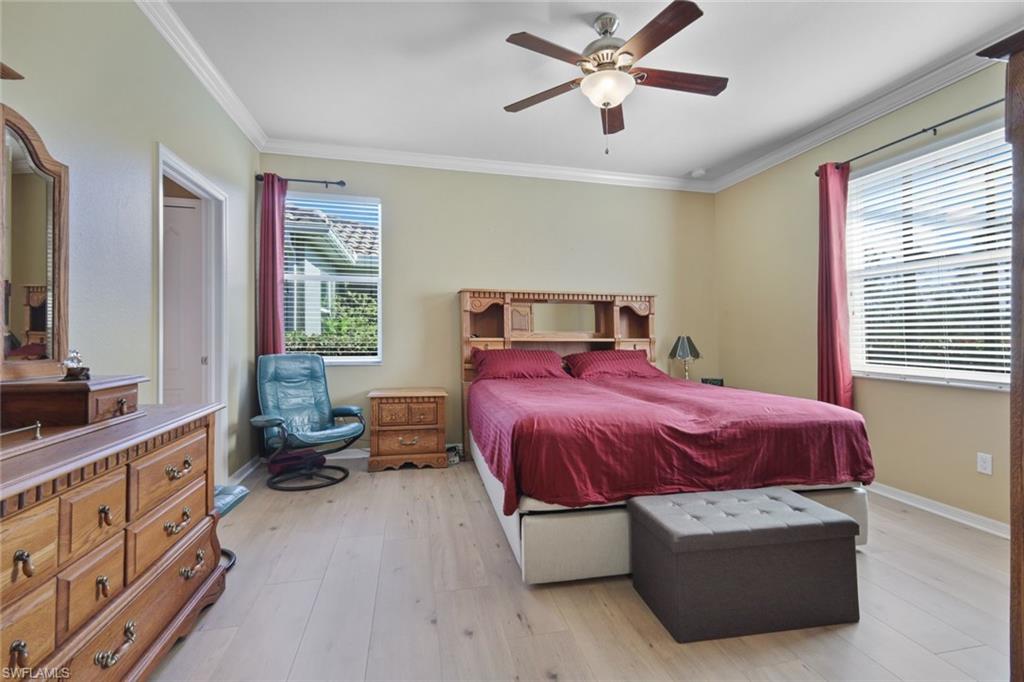 21025 Bella Terra Boulevard Estero, FL 33928 - Photo 12 of 35 a spacious bedroom with a bed and a chandelier