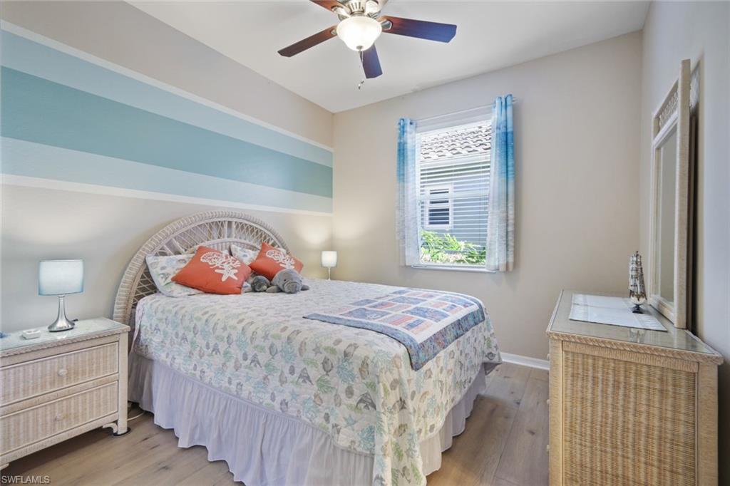 21025 Bella Terra Boulevard Estero, FL 33928 - Photo 15 of 35 a bedroom with a bed and a chandelier