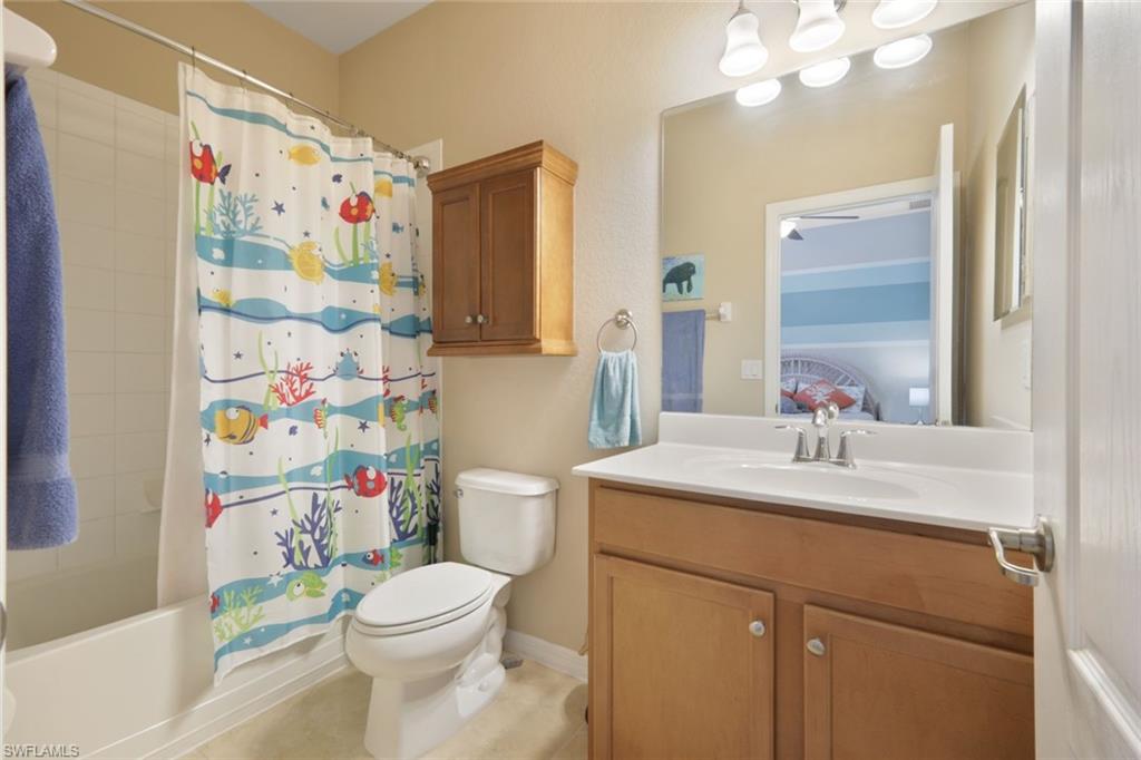 21025 Bella Terra Boulevard Estero, FL 33928 - Photo 16 of 35 a bathroom with a sink vanity mirror and toilet