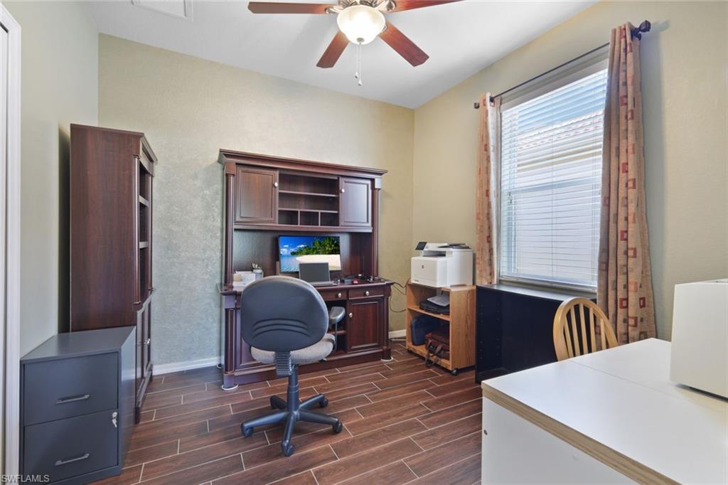 21025 Bella Terra Boulevard Estero, FL 33928 - Photo 19 of 35 a workspace with furniture and wooden floor