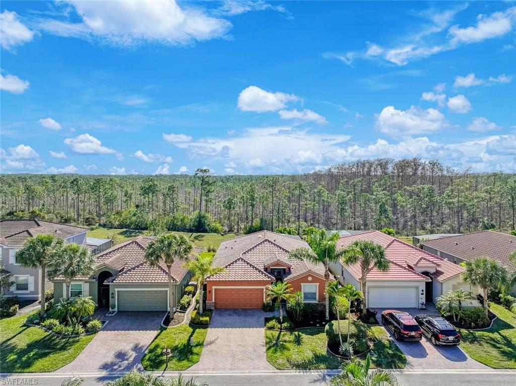 21025 Bella Terra Boulevard Estero, FL 33928 - Photo 22 of 35 a view of multiple houses with yard and outdoor seating