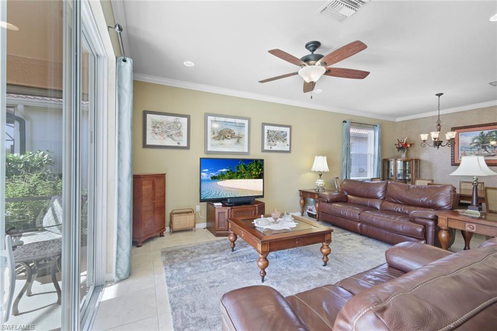 21025 Bella Terra Boulevard Estero, FL 33928 - Photo 2 of 35 a living room with furniture a table and a window