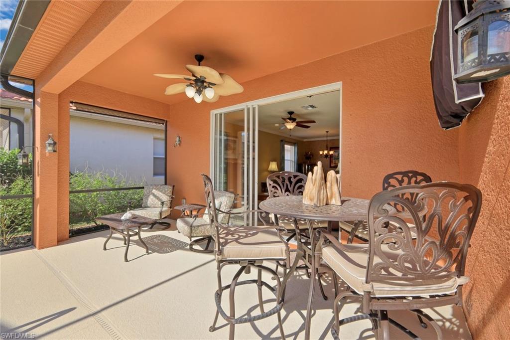 21025 Bella Terra Boulevard Estero, FL 33928 - Photo 8 of 35 a view of a dining room with furniture and chandelier