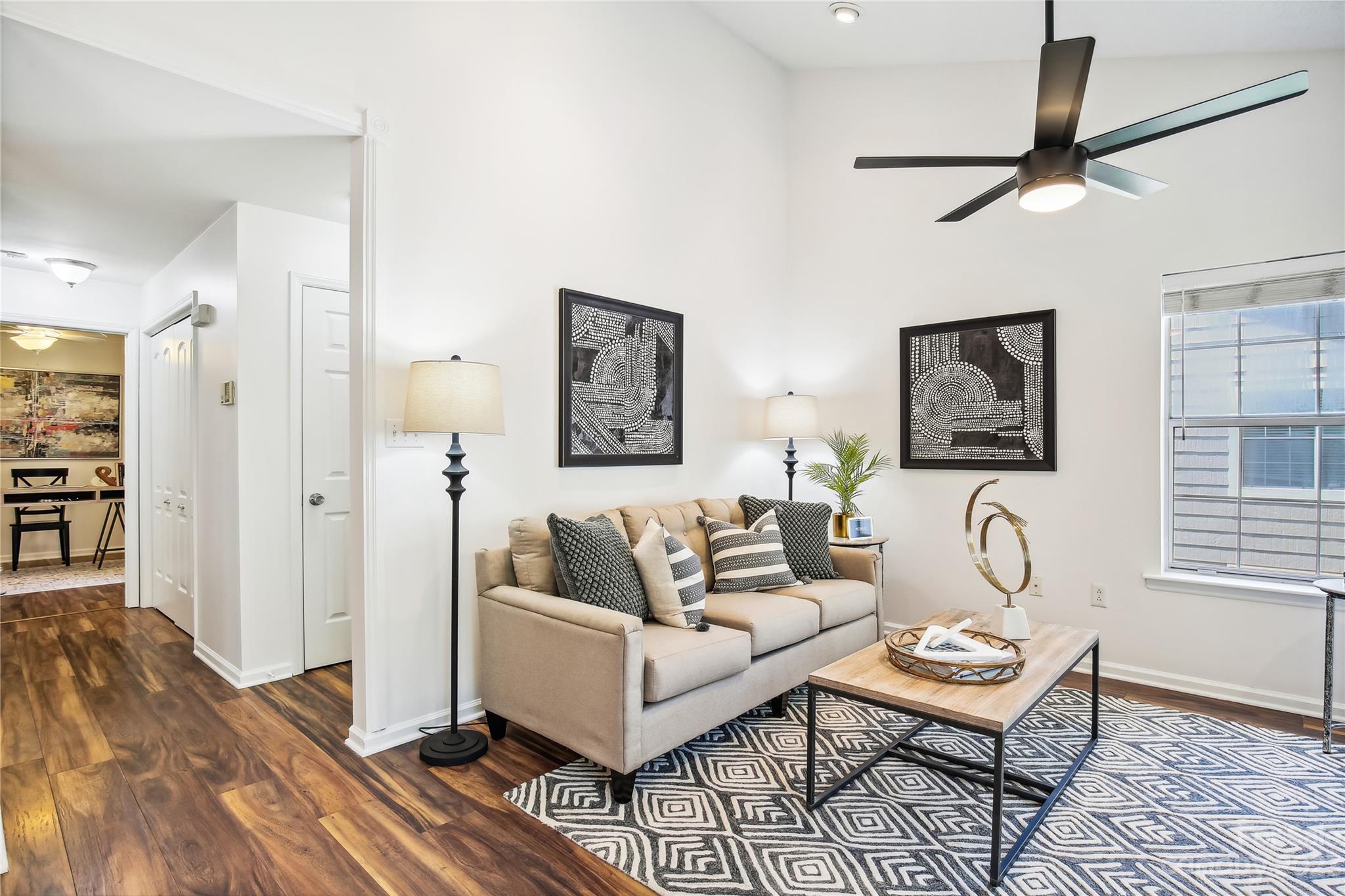 5007 Sharon Road, Unit E Charlotte, NC 28210 - Photo 14 of 30 a living room with furniture a rug and a window