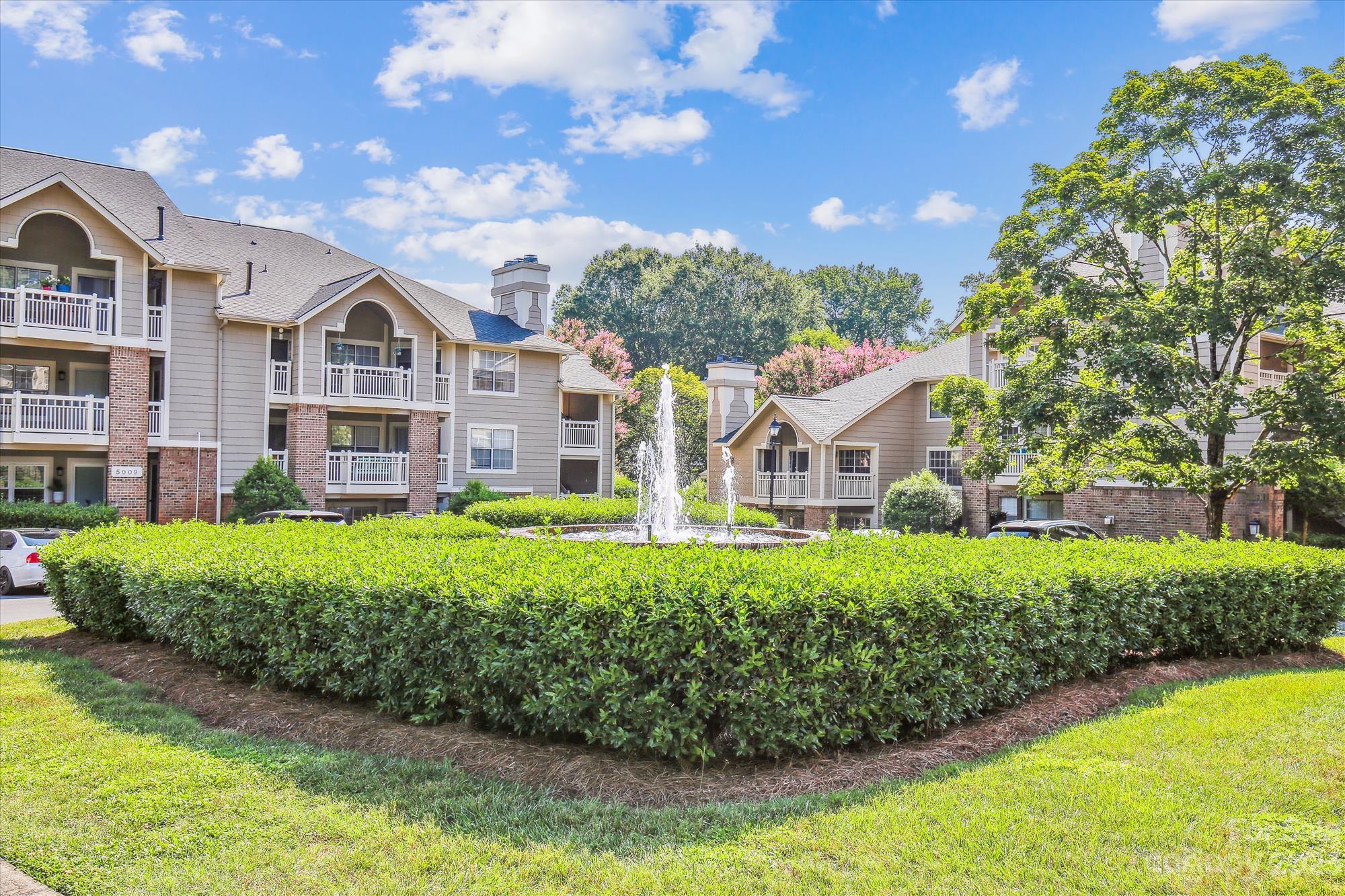 5007 Sharon Road, Unit E Charlotte, NC 28210 - Photo 27 of 30 a front view of a house with a yard