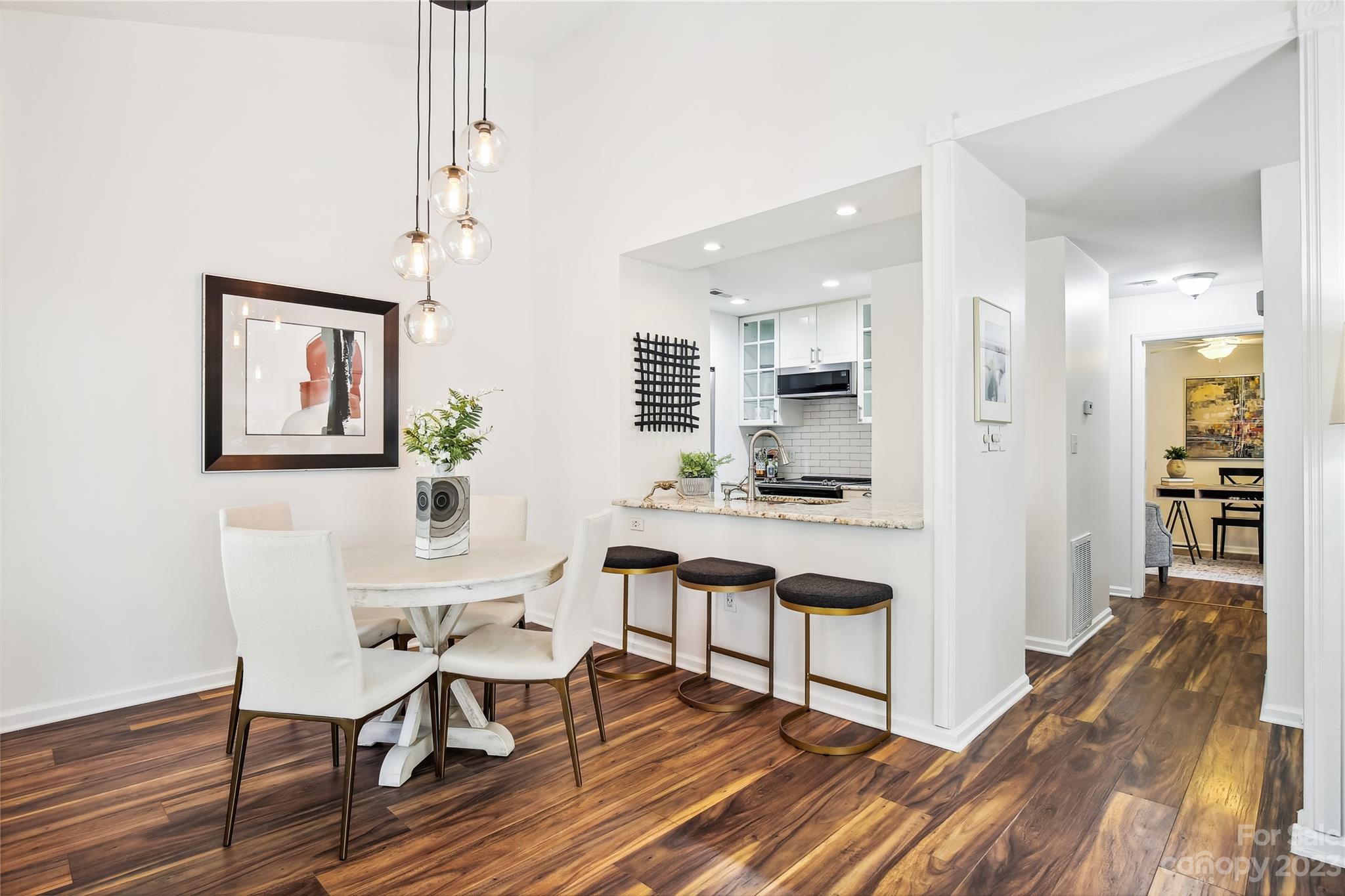 5007 Sharon Road, Unit E Charlotte, NC 28210 - Photo 4 of 30 a view of a dining room with furniture and wooden floor