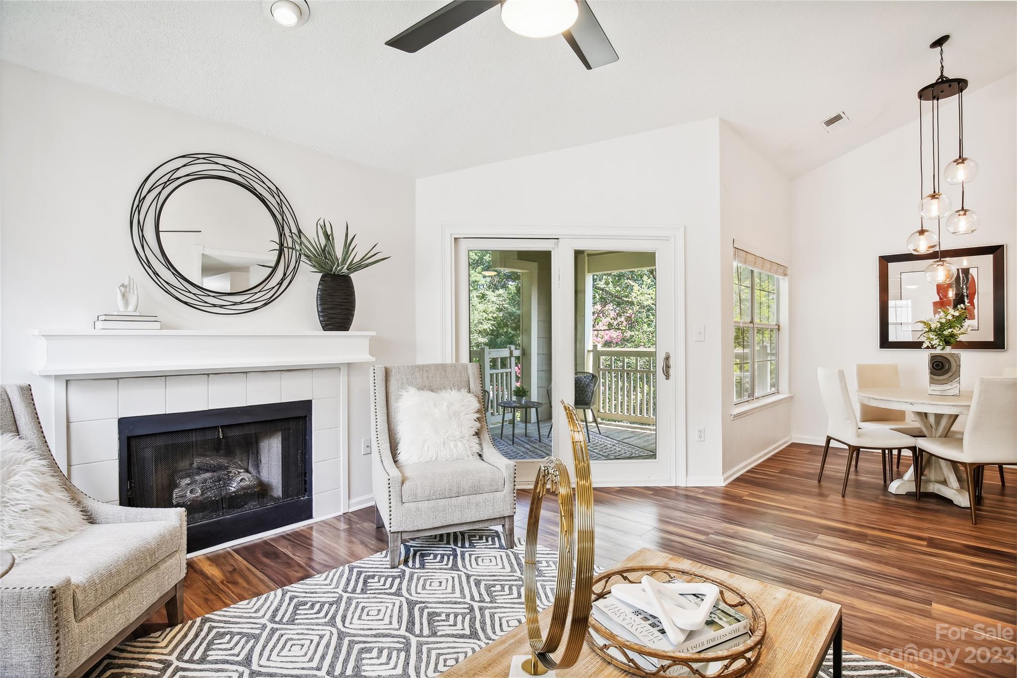 5007 Sharon Road, Unit E Charlotte, NC 28210 - Photo 5 of 30 a living room with furniture a fireplace and wooden floor