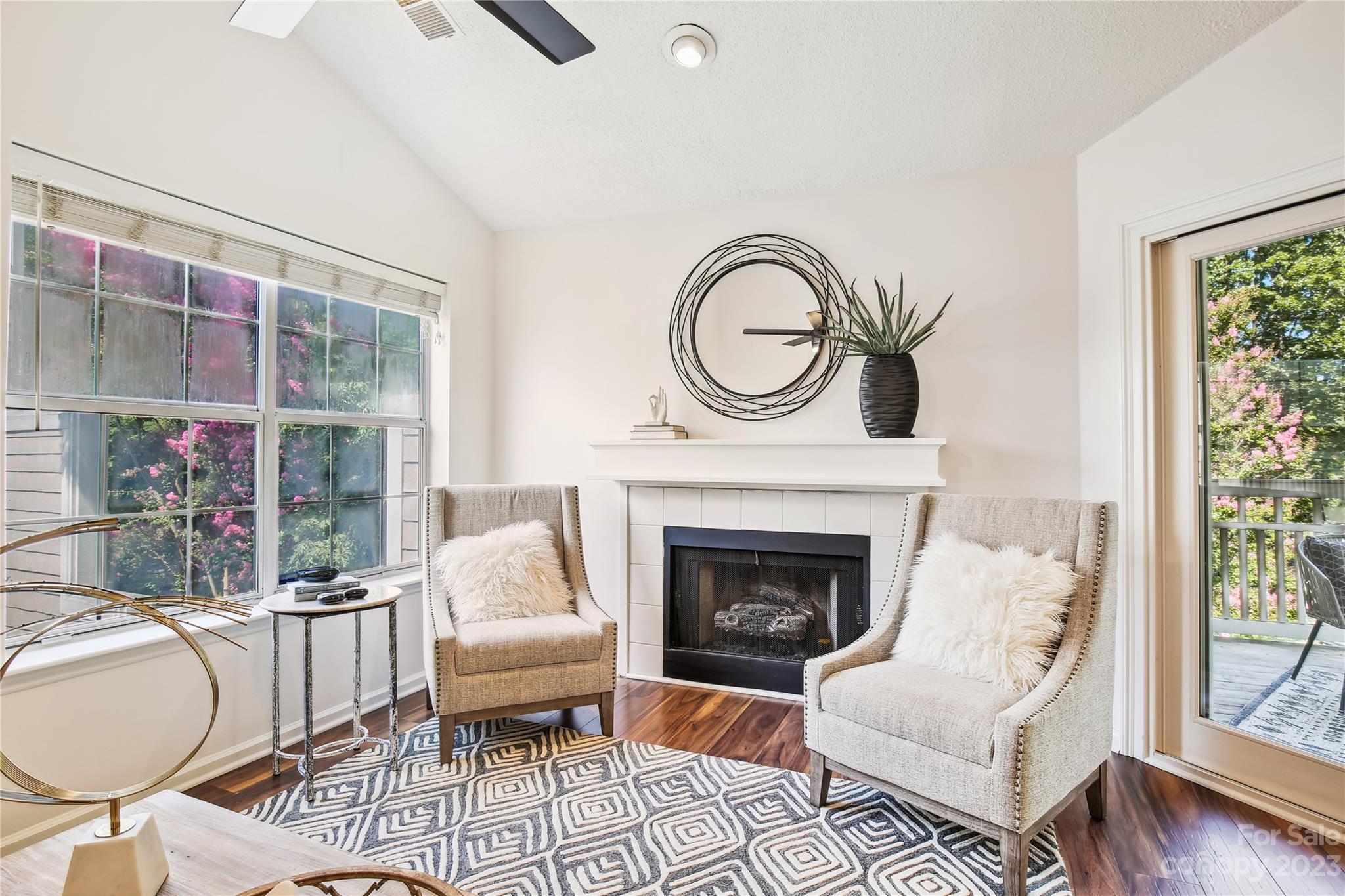5007 Sharon Road, Unit E Charlotte, NC 28210 - Photo 6 of 30 a living room with furniture a fireplace and a floor to ceiling window