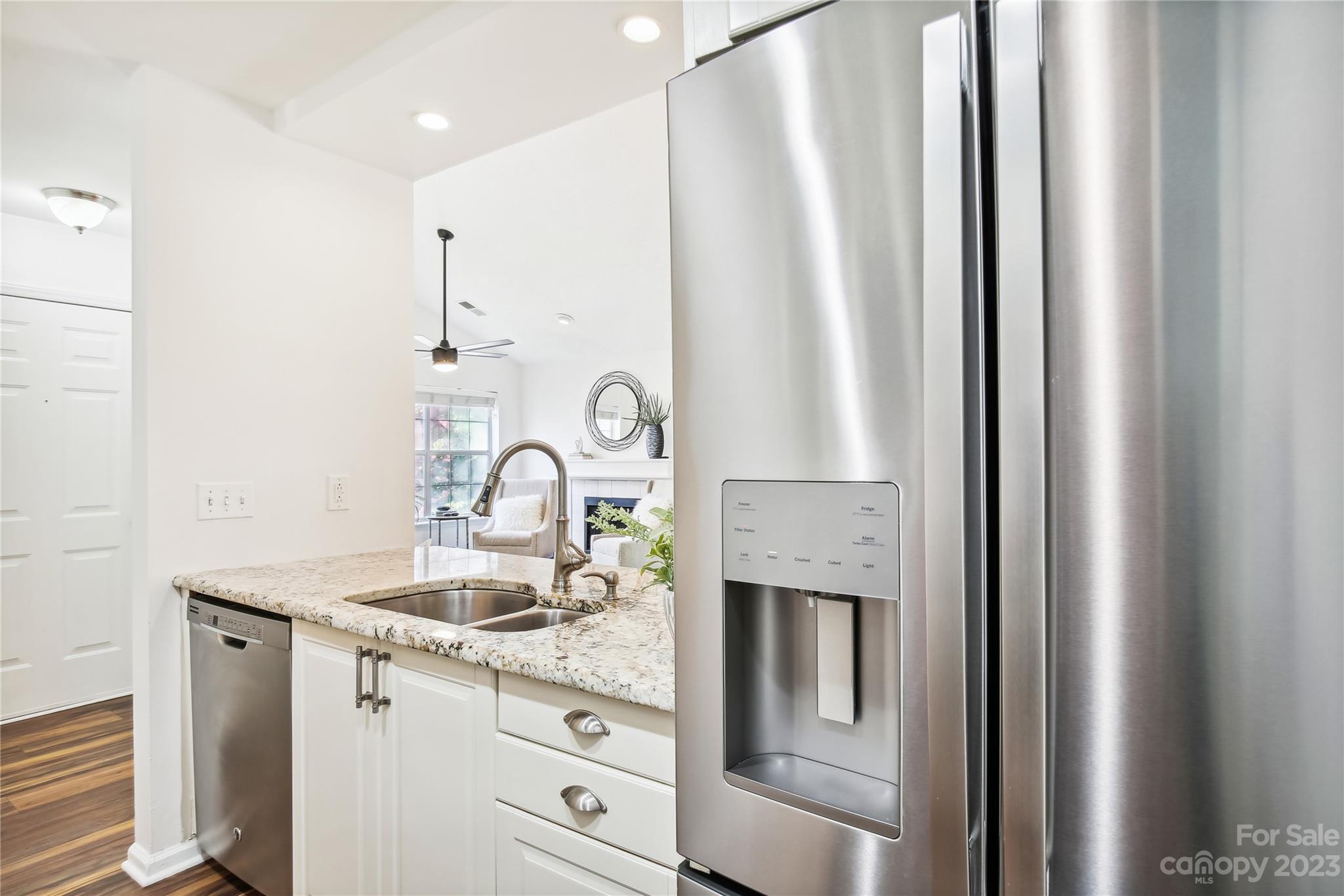 5007 Sharon Road, Unit E Charlotte, NC 28210 - Photo 8 of 30 a kitchen with stainless steel appliances granite countertop a refrigerator and a sink