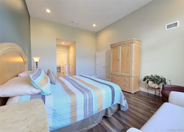 a kitchen with stainless steel appliances a dining table chairs refrigerator sink and cabinets