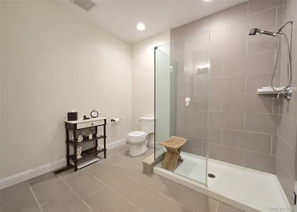 a spacious bathroom with a double vanity sink and a mirror