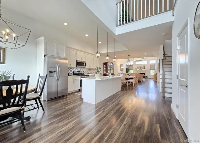 a view of a dining room with furniture wooden floor and chandelier