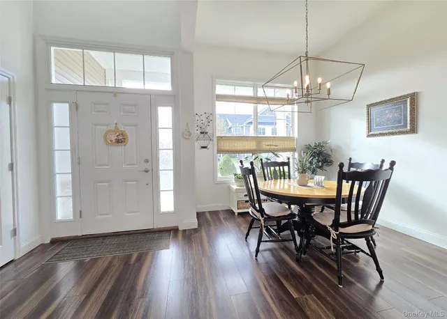 a kitchen with kitchen island granite countertop a sink cabinets and wooden floor
