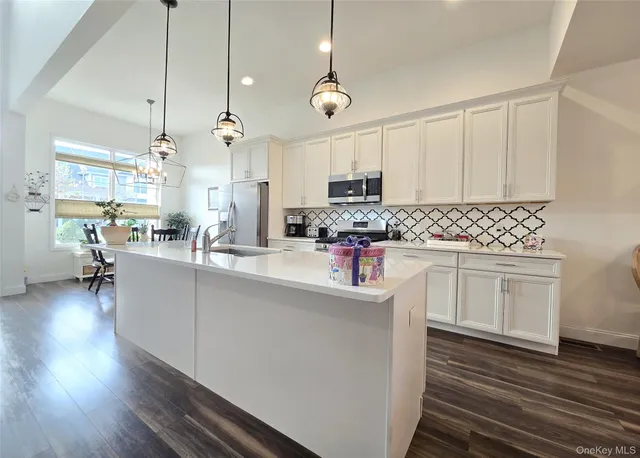 a large kitchen with stainless steel appliances kitchen island a large island in the center