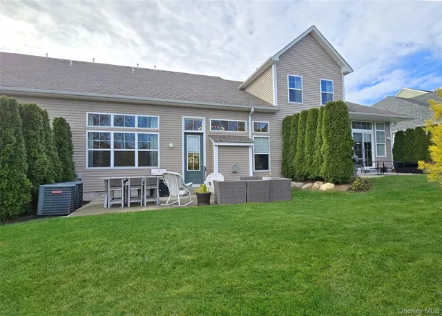 a view of a house with a yard and porch
