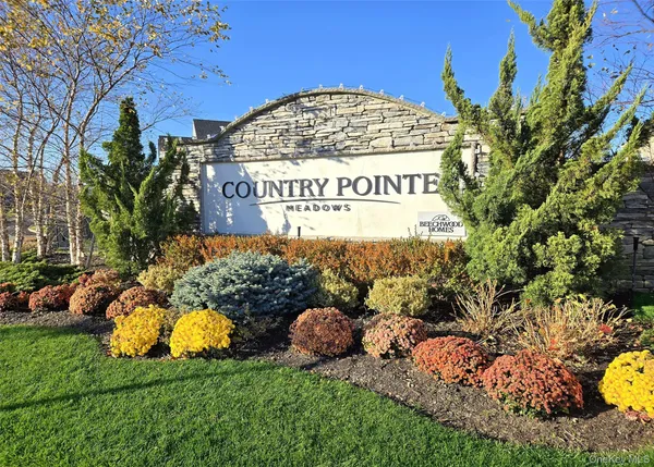 a view of a sign board with a garden