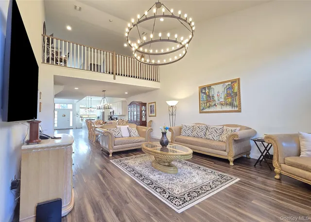 a living room with furniture and a chandelier