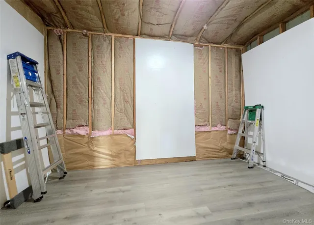 a view of a room with wooden floor and furniture
